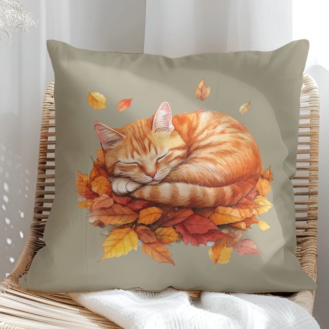 Cosy Sleeping Ginger Cat Olive Pillow  (Cozy Sleeping Ginger Cat Terracotta Pillow in a sunny boho rattan chair.)