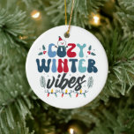 Cosy Winter Vibes Photo Christmas Ceramic Tree Decoration<br><div class="desc">Bring the warmth of the season to your tree with this “Cosy Winter Vibes” photo ornament! Featuring playful typography,  festive holly,  twinkling lights,  and a snuggly snowman,  this double-sided keepsake lets you add a cherished photo on the back. Perfect for gifting,  memory-making,  or simply embracing those hygge holiday feels!</div>