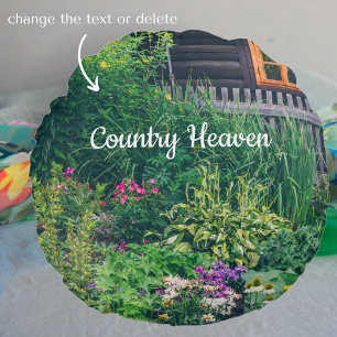 Countryside house with a colourful garden round cushion