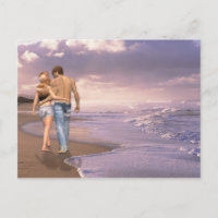 Couple in Love Walking on Beach into the Sunset