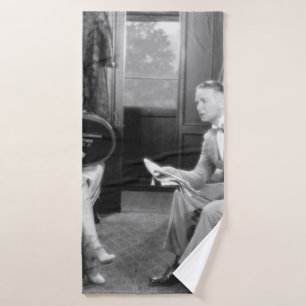 Couple sitting together in a compartment of a trai bath towel