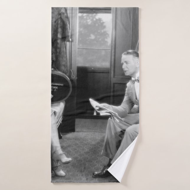 Couple sitting together in a compartment of a trai bath towel (Bath Towel)