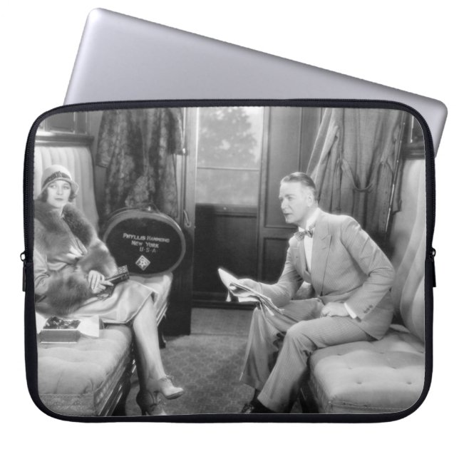 Couple sitting together in a compartment of a trai laptop sleeve (Front)