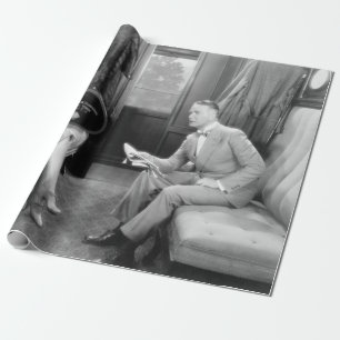 Couple sitting together in a compartment of a trai wrapping paper