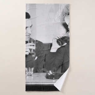 Couple sitting together in a restaurant flirting w bath towel