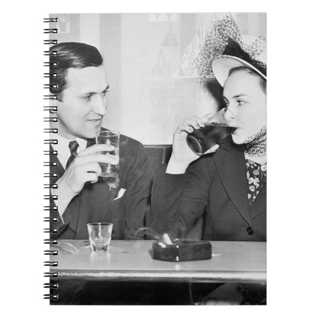Couple sitting together in a restaurant flirting w notebook (Front)