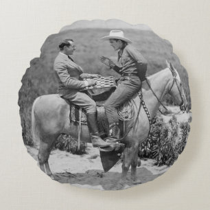 Cowboy and businessman playing checkers on horseba round cushion