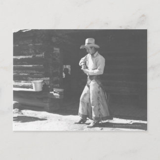 Cowboy eating from a Peter Pan peanutbutter can. Postcard