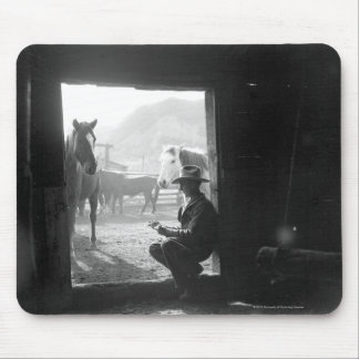Cowboy in a doorway with horses mouse pad