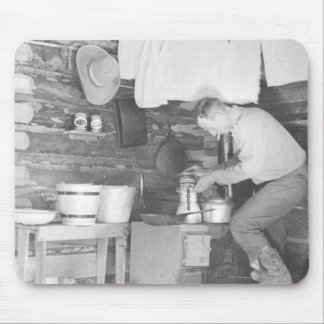 Cowboy making coffee inside the bunkhouse mouse pad