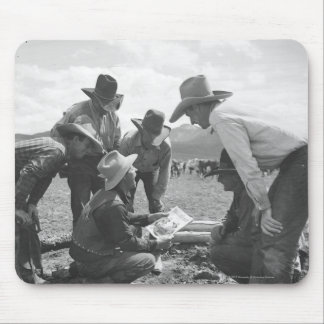 Cowboys looking a magazine mouse pad