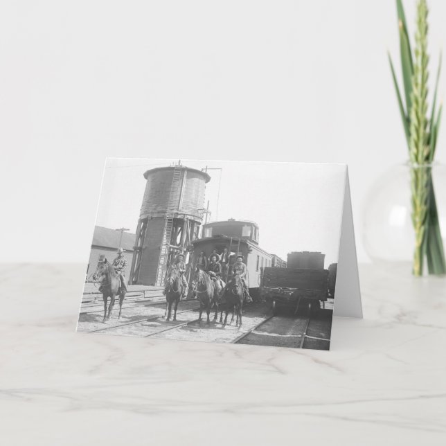 Cowboys on horses posing in front of a train card (Front)