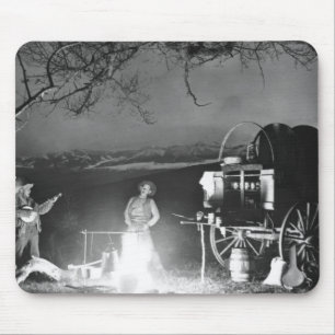 Cowboys playing and singing around a campfire mouse pad