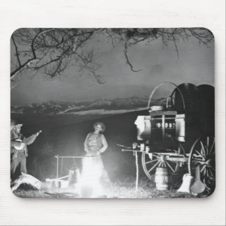 Cowboys playing and singing around a campfire mouse pad