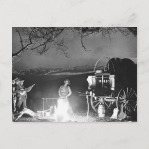 Cowboys playing and singing around a campfire postcard