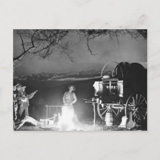 Cowboys playing and singing around a campfire postcard