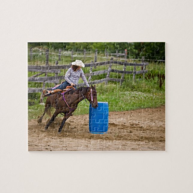 Cowgirl on horseback practicing barrel racing in jigsaw puzzle (Horizontal)
