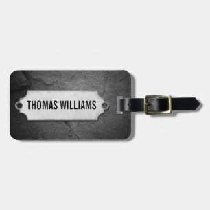 cracked black stone texture with metal tag