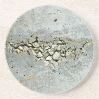Cracked concrete wall with small stones coaster