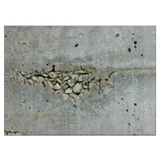 Cracked concrete wall with small stones cutting board