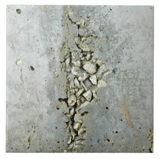Cracked concrete wall with small stones tile