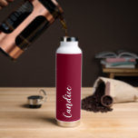 Cranberry Red Personalised Wedding Bridesmaid Water Bottle<br><div class="desc">Gift your wedding bridesmaid or maid of honour with this trendy, vacuum Insulated water bottle that features her name in white, stylised script on a cranberry red colour background designed to match your wedding colour scheme. Personalise bottle by editing and replacing name with your own as desired. Select your water...</div>