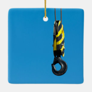 Crane hook with yellow and black stripes hanging ceramic tree decoration