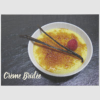 Creme brulee on slate with raspberry and vanilla