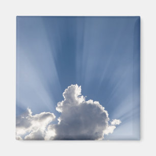 Crepuscular or God's rays streak past cloud. Magnet