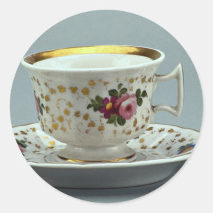 Cup and saucer with colourful flower designs on classic round sticker