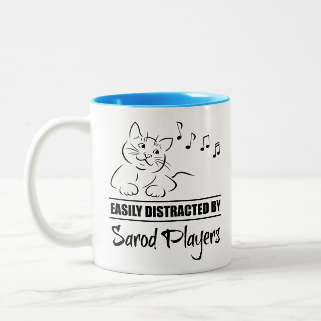 Curious Cat Easily Distracted by Sarod Players Two-Tone Coffee Mug (Left)