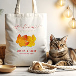 Custom Fall Wedding Welcome Bag Two Leaves<br><div class="desc">Fall wedding welcome bag for a destination wedding event. Two orange, red and yellow leaves represent the couple. Black text can be customized in four places to include names of the bride and groom, with wedding date and location. Welcome traveling guests to their hotel rooms with this personalized gift bag....</div>