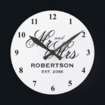 Custom Mr and Mrs newlyweds wedding gift clock<br><div class="desc">Custom Mr and Mrs newlyweds wedding gift clock. Elegant script typography template with family name and date of marriage. Classy presents for just married couple or bride and groom. Chic black and white design home decor. Personalised decor for unique kitchen, office, living room, bedroom etc. Add your own established year...</div>