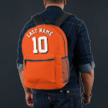 Custom Orange White Last Name Sports Jersey Number Printed Backpack<br><div class="desc">Custom-designed sports jersey backpack in vibrant orange with striking white lettering and bold black shadow detailing for your last name and chosen number. This personalised backpack is a must-have for sports enthusiasts, adding a touch of individuality to your gear collection. Crafted with durability in mind, it ensures long-lasting performance while...</div>