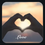 Custom Text Love Hands Heart Shape Twilight Sunset Square Sticker<br><div class="desc">Decorate your space in style with this beautiful custom text sticker. This design features a person in shadow with their hands in the shape of a heart. The hands are framing the setting sun at twilight. The sky and clouds are in shades of dusky blue, orange, and gold, and there...</div>