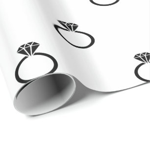 Customisable Black Engagement Rings on White Wrapping Paper
