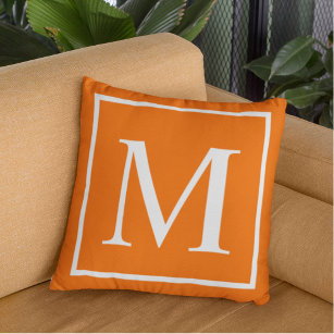 Customise monogram on bright orange cushion