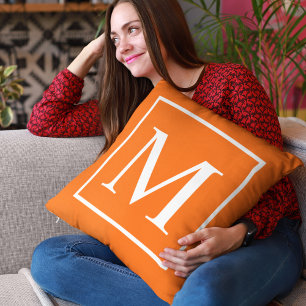 Customise monogram on bright orange cushion