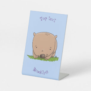 Cute baby wombat cartoon illustration pedestal sign