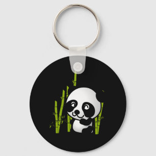 Cute black and white panda bear in a bamboo grove. key ring