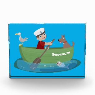Cute boy sailor and dog rowing boat cartoon photo block