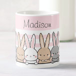 Cute Bunnies Personalised Coffee Mug<br><div class="desc">Enjoy your favourite beverages in style with this adorable custom name mug, featuring a charming row of cute bunnies set against a soft pink background. Perfect for kids and animal lovers alike, this high-quality mug can be personalised with any name, making it a unique and thoughtful gift. Whether for morning...</div>