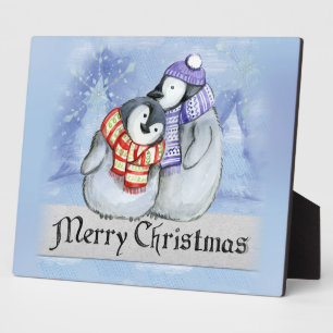 Cute couple of penguins hugging plaque
