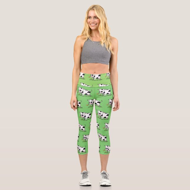 Cute cow in green field cartoon illustration capri leggings (Front)