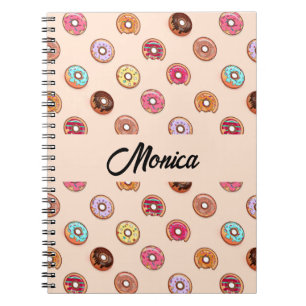 Cute decorative doughnuts on pink notebook