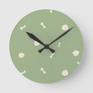 Cute Dog Paw Prints and Bones Pattern on Green Round Clock