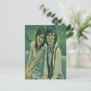 Cute friends sitting next to each other postcard