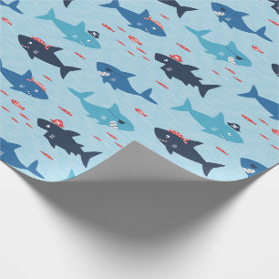 Cute funny sharks with pirate hats on blue wrapping paper