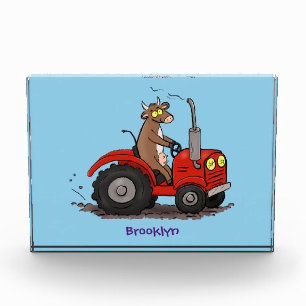 Cute happy cow driving a red tractor cartoon photo block
