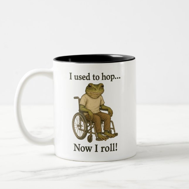 Cute little frog in a wheelchair being positive. Two-Tone coffee mug (Left)